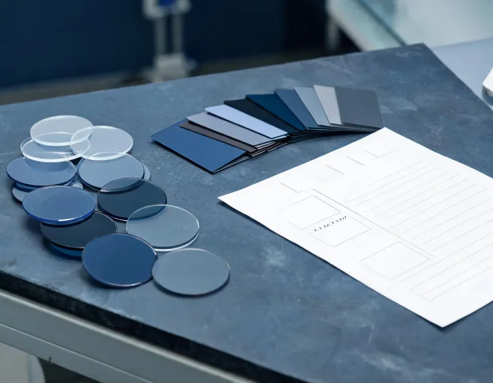 Custom sunglass lenses blanks beside a specification worksheet